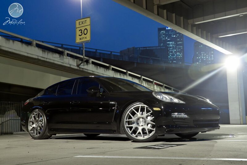 Black Porsche Panamera under overpass