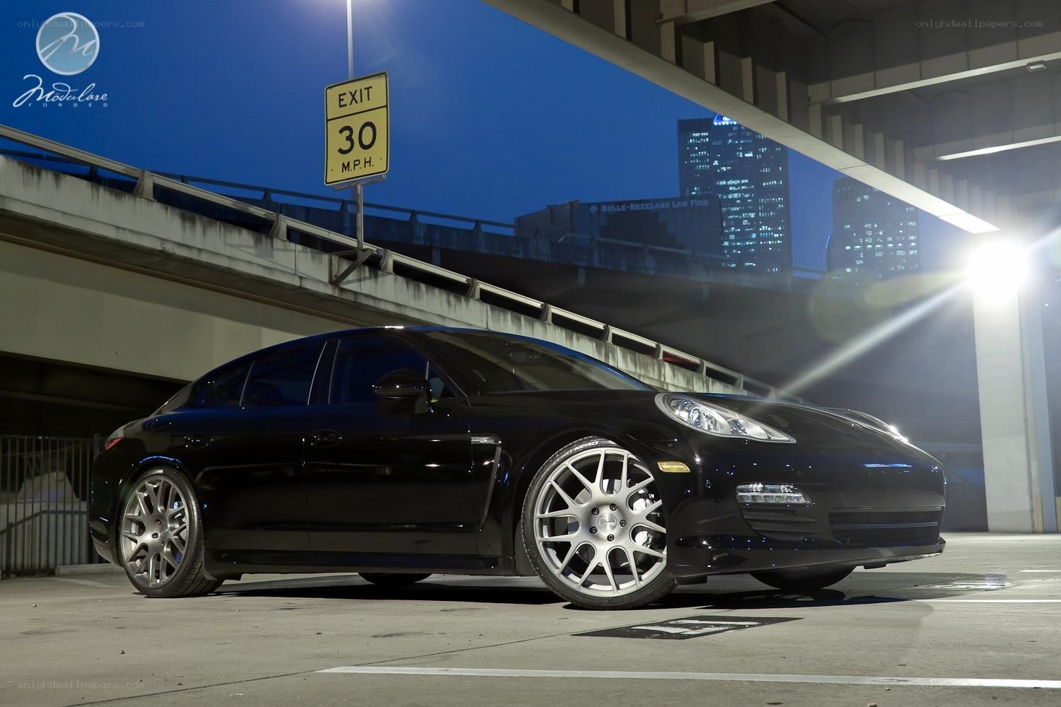 Black Porsche Panamera under overpass