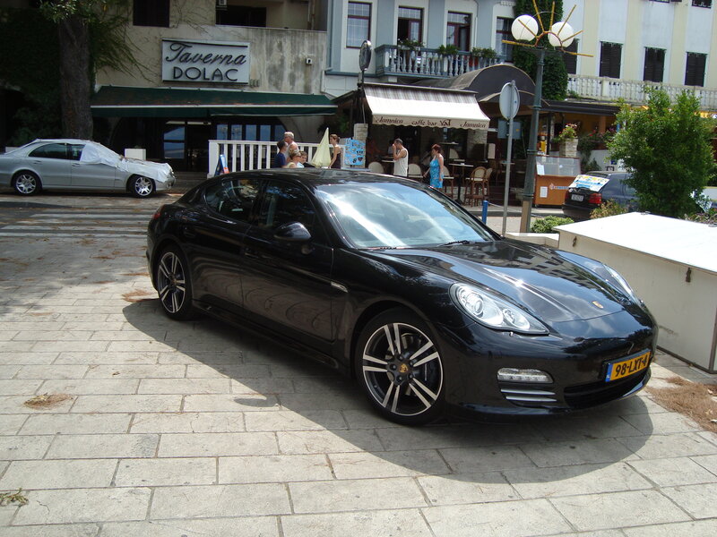 Black Porsche parked on a street