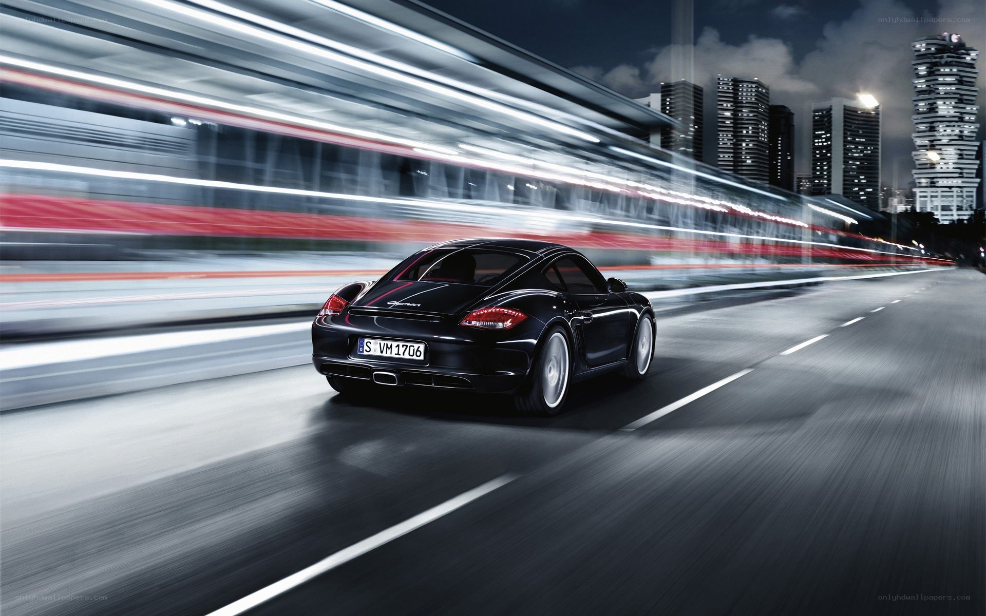 Black Porsche speeding at night