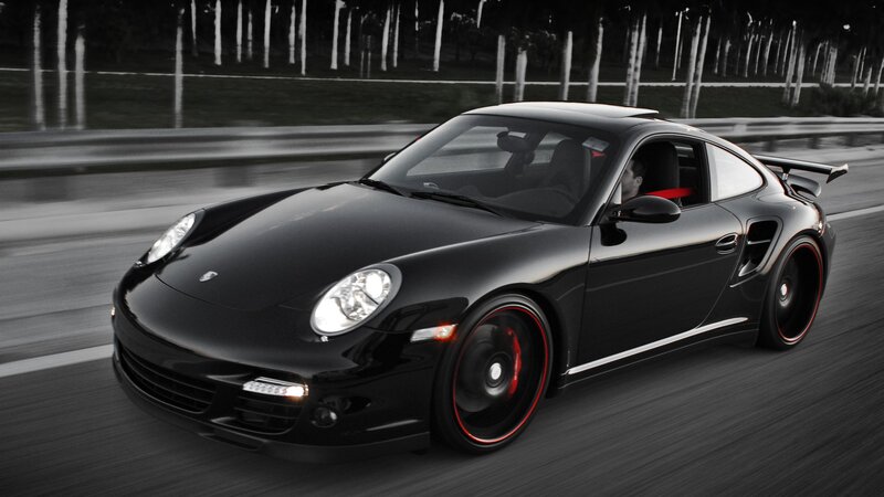 Black Porsche speeding on road