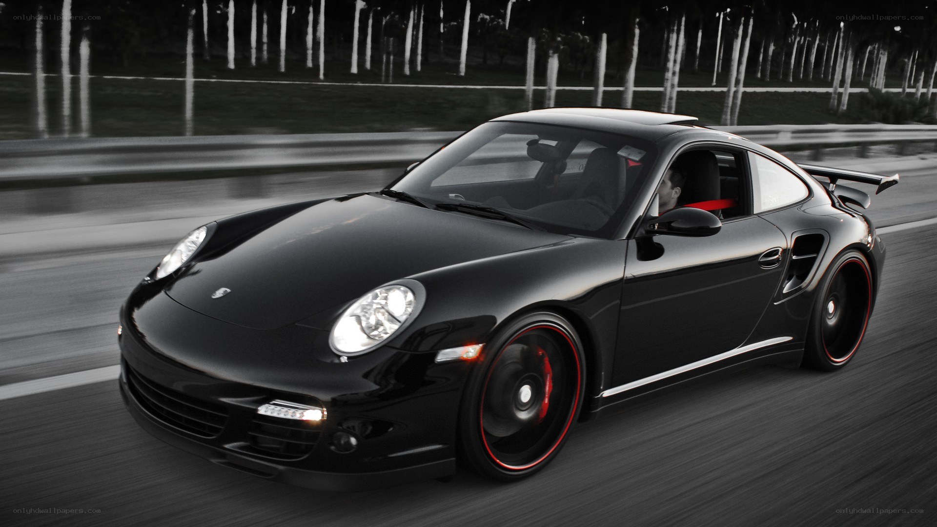 Black Porsche speeding on road