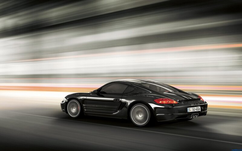 Black Porsche sports car in motion