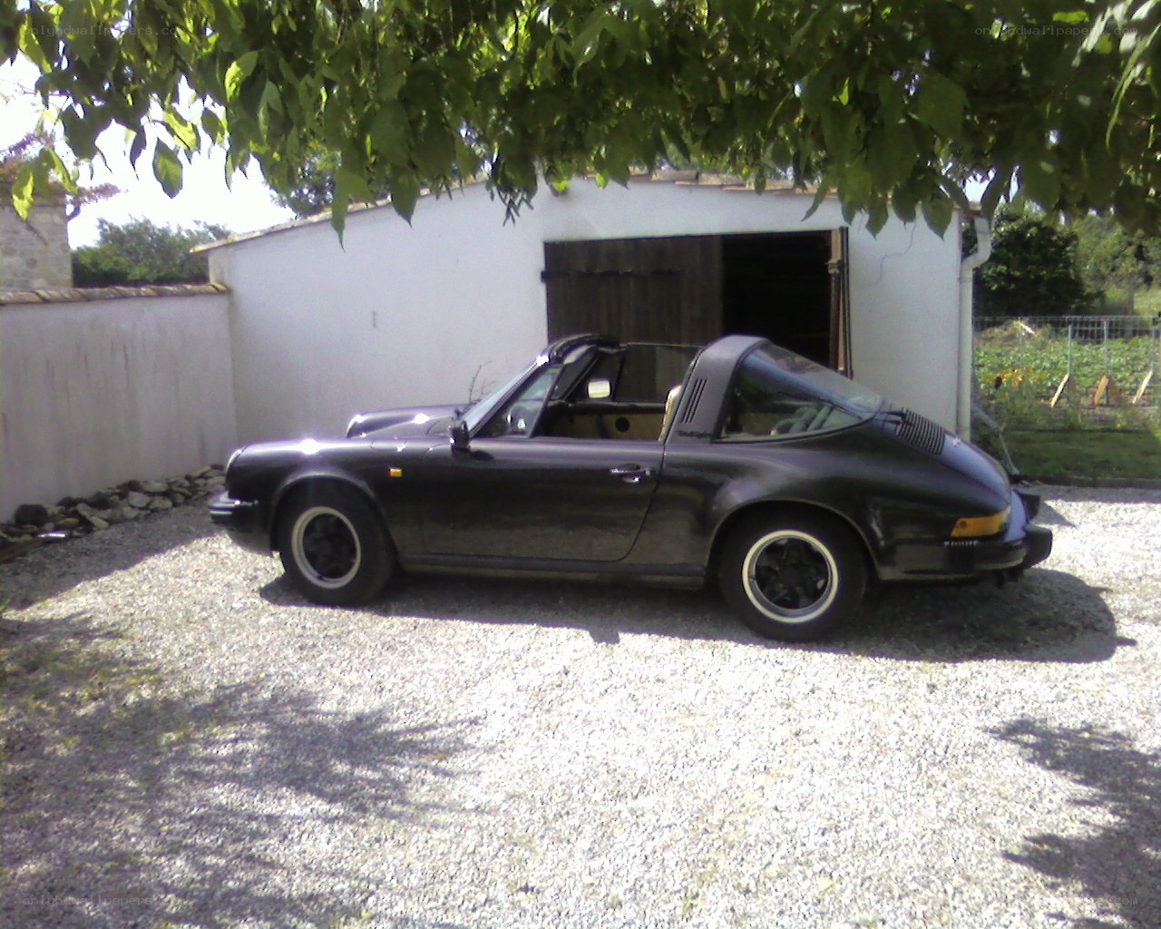 Black Porsche Targa parked outside