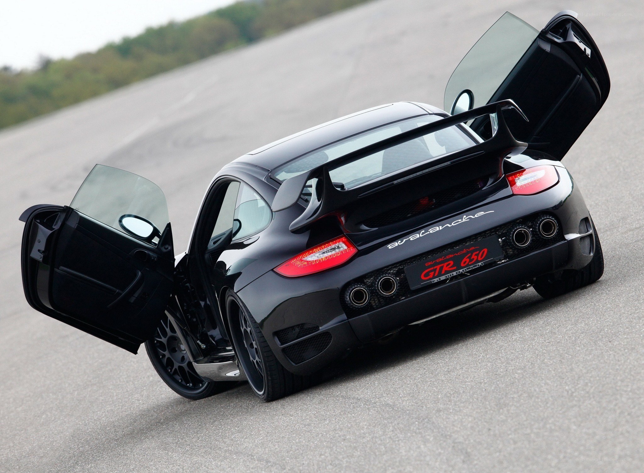 Black Porsche with open doors