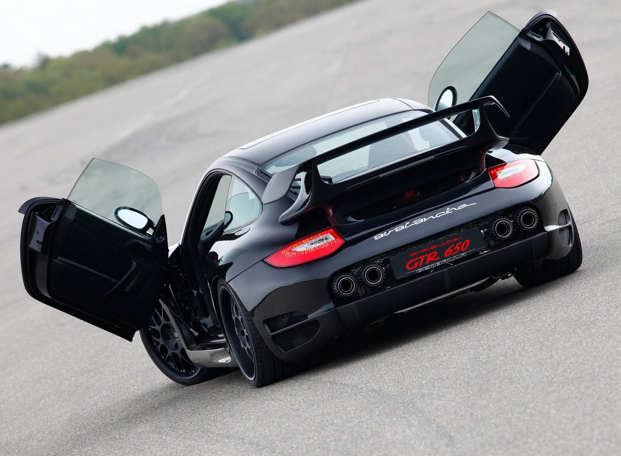 Black Porsche with open doors