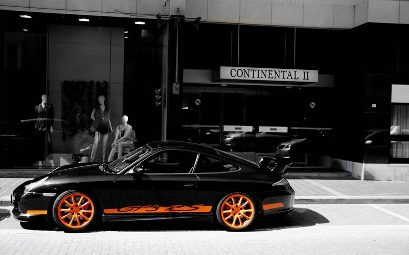 Black Porsche with orange accents