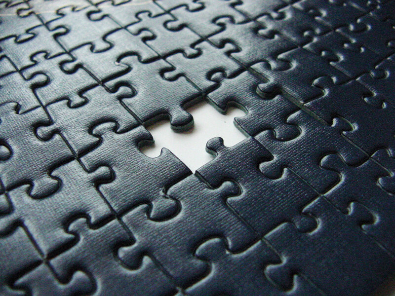 black puzzle with missing piece