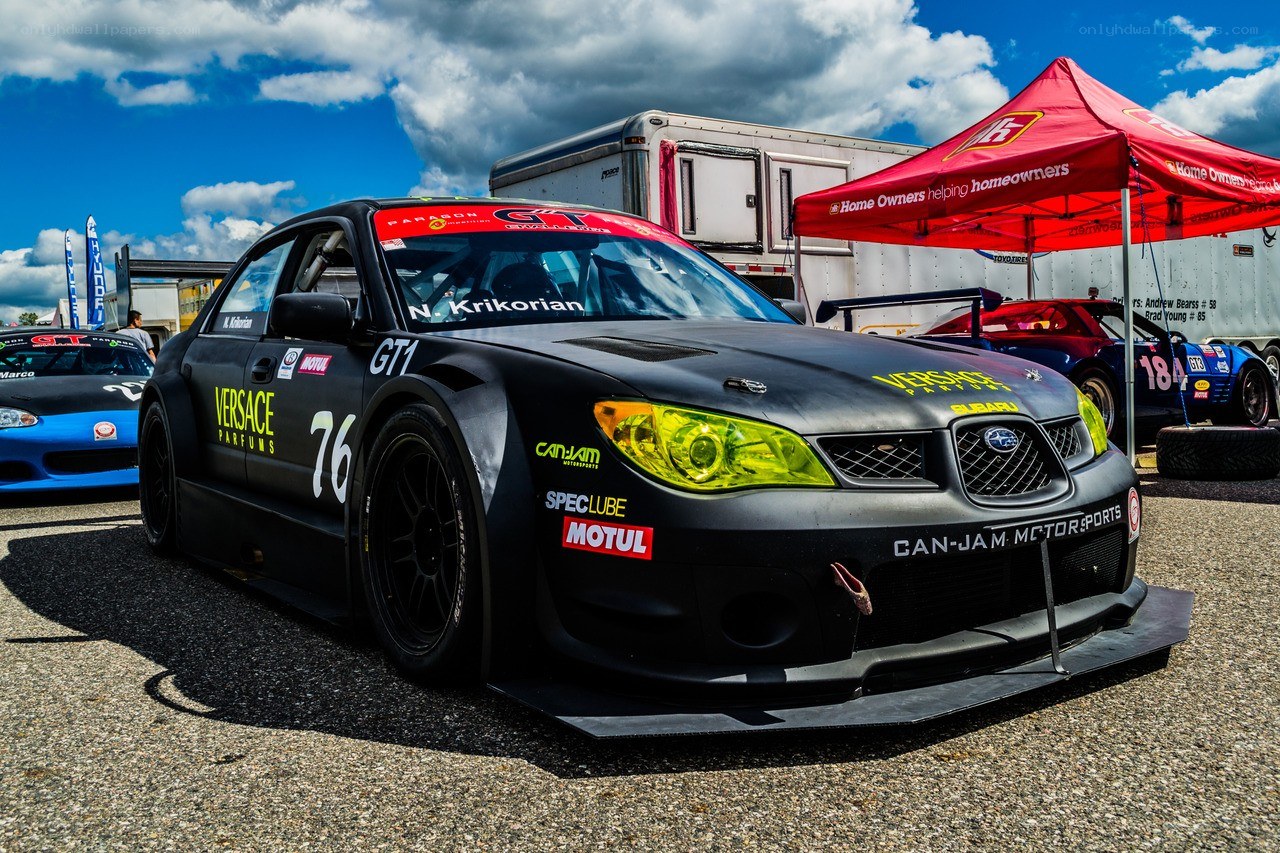 Black race car at a racetrack