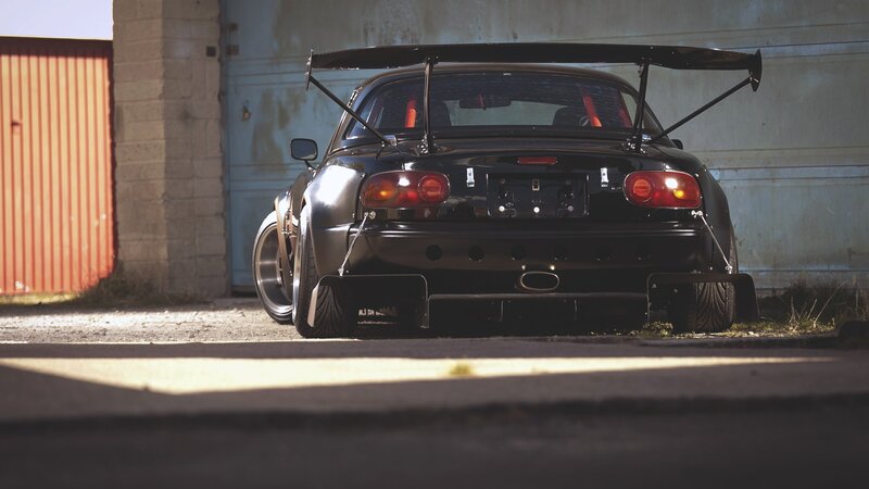 Black Race Car — Dramatic, Afternoon, Photograph, Garage Door