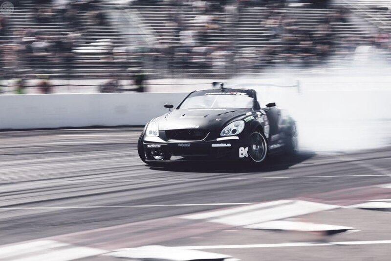 Black race car drifting on track