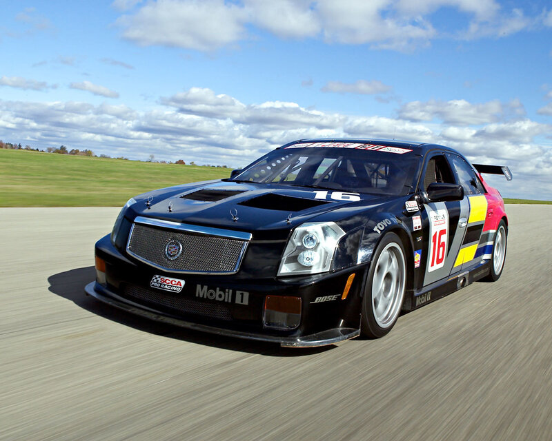 Black Race Car — Dynamic, Afternoon, Photograph, Race Track, Grass Field