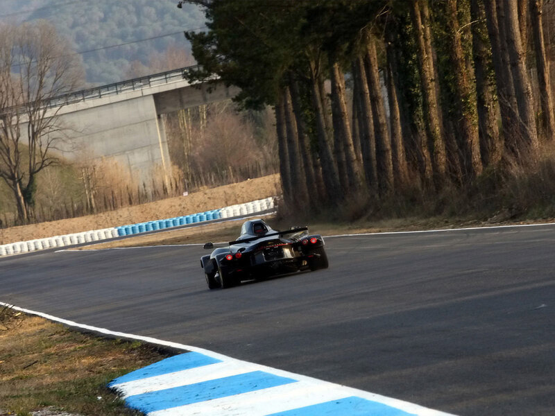 Black Race Car — Dynamic, Afternoon, Photograph, Race Track, Trees, Bridge