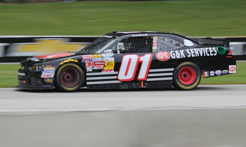 Black Race Car — Dynamic, Photograph, Race Track, Grass