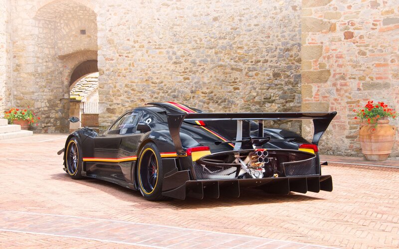 black race car on brick courtyard