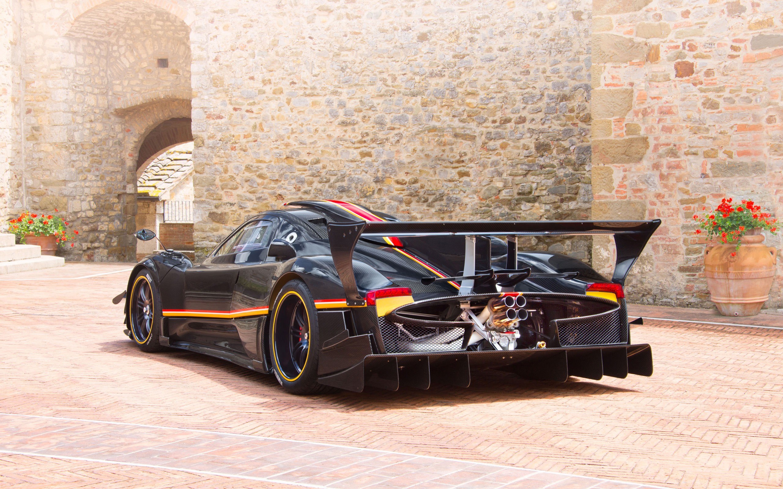 black race car on brick courtyard