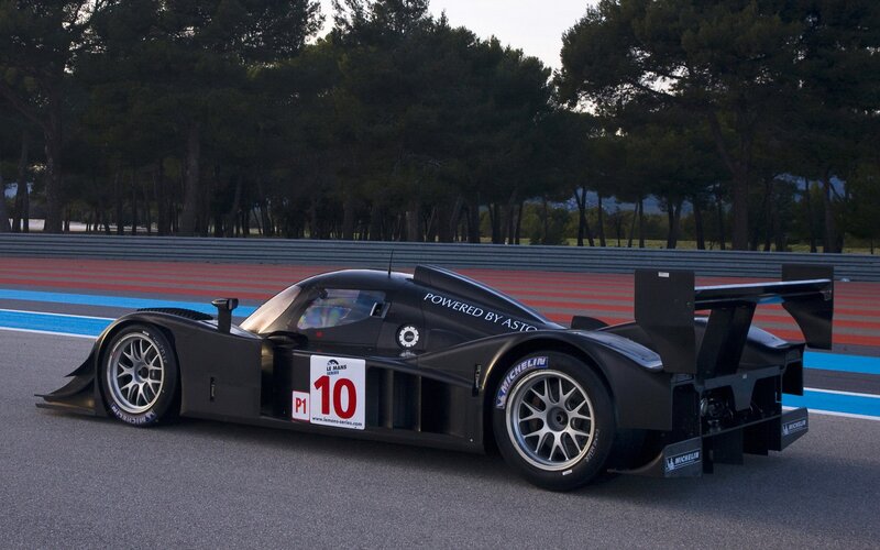 Black Race Car on Track — Calm, Sunset