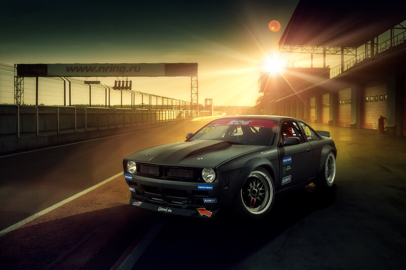 Black Race Car on Track — Dramatic, Sunrise