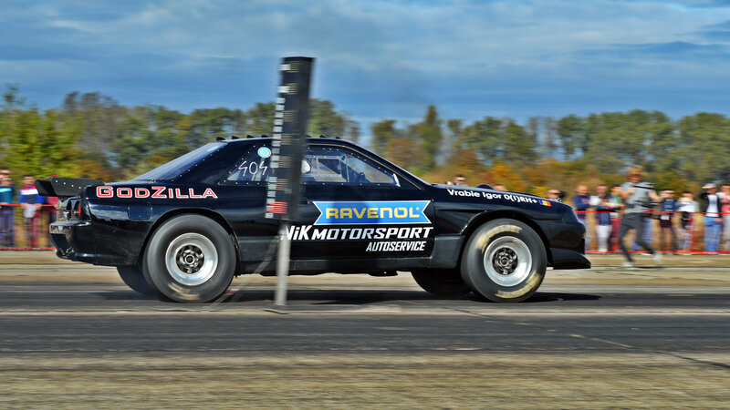 Black Race Car on Track — Dynamic, Afternoon, Photograph, Crowd