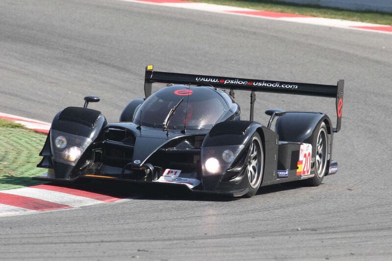 Black Race Car on Track — Dynamic, Afternoon, Photograph, Race Car, Driver, Gray, Red