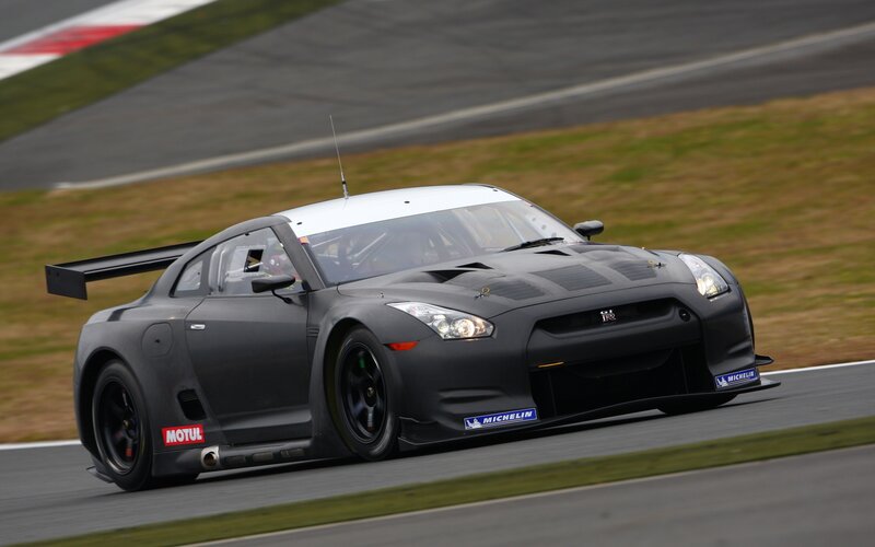 Black Race Car on Track — Dynamic, Afternoon, Photograph, Race Car, Grass, Gray