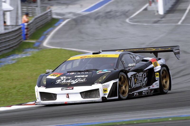 Black Race Car on Track — Dynamic, Afternoon, Photograph, Race Car, Grass, Guardrail