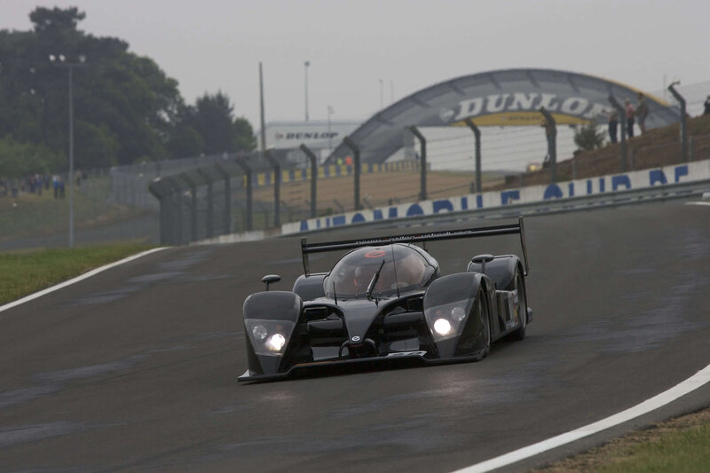 Black Race Car on Track — Dynamic, Afternoon, Photograph, Race Track, Spectators