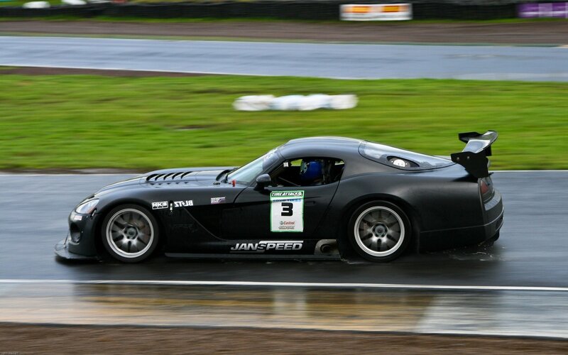 black race car on wet track