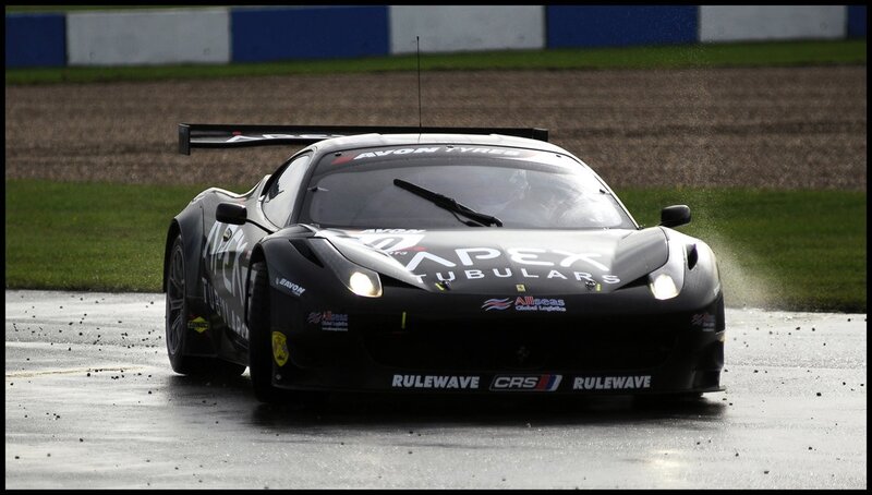 Black race car on wet track