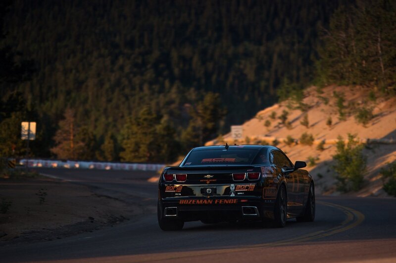 Black race car on winding road