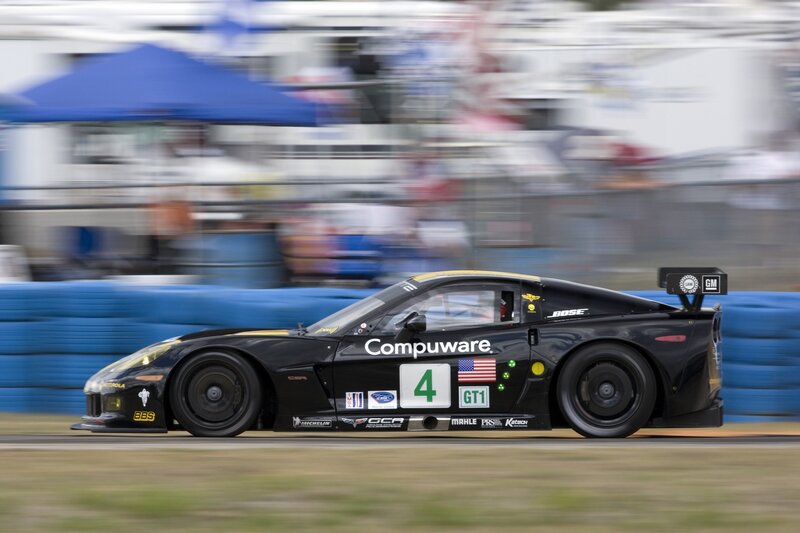 Black race car speeding on track