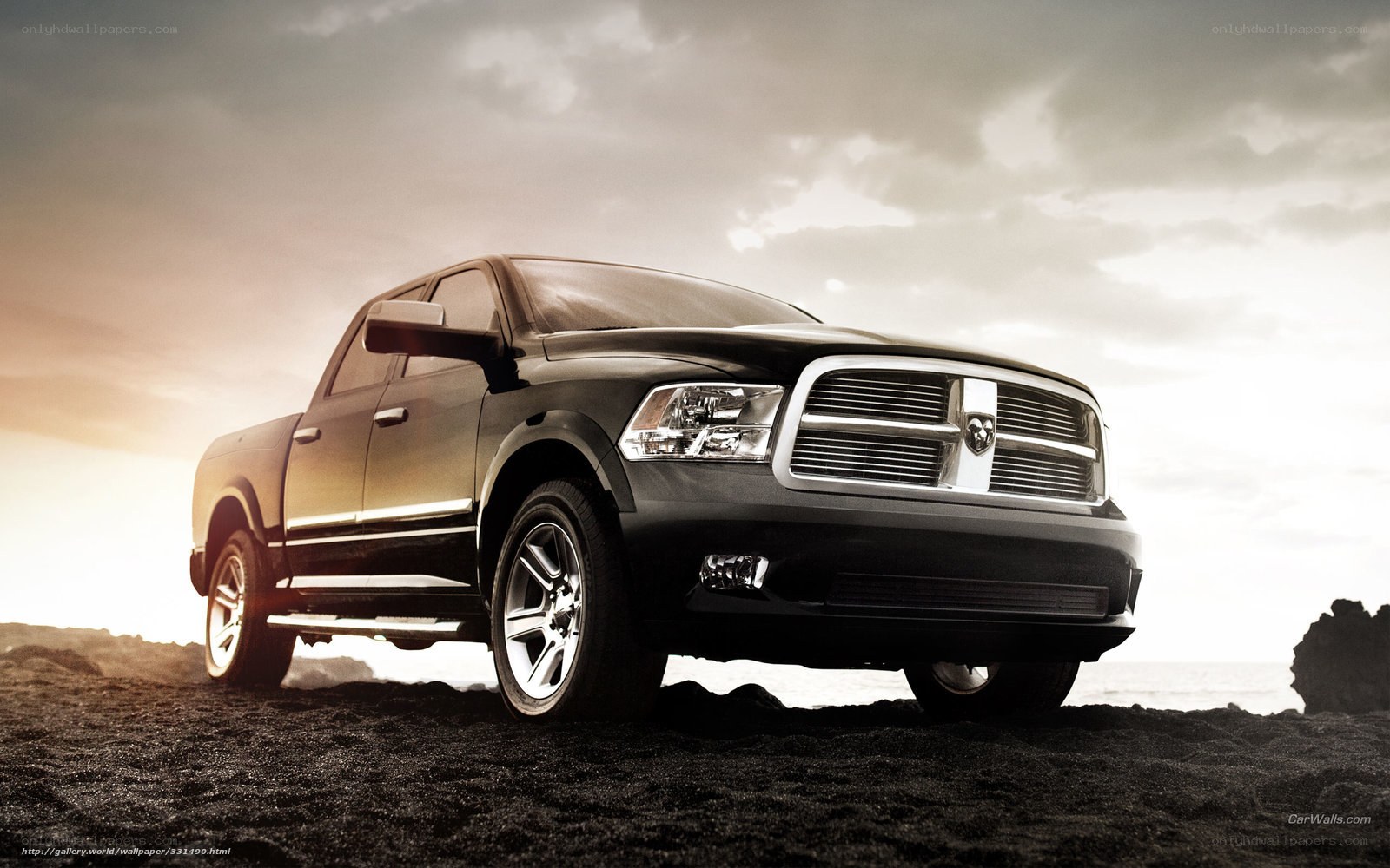 Black Ram pickup truck on beach