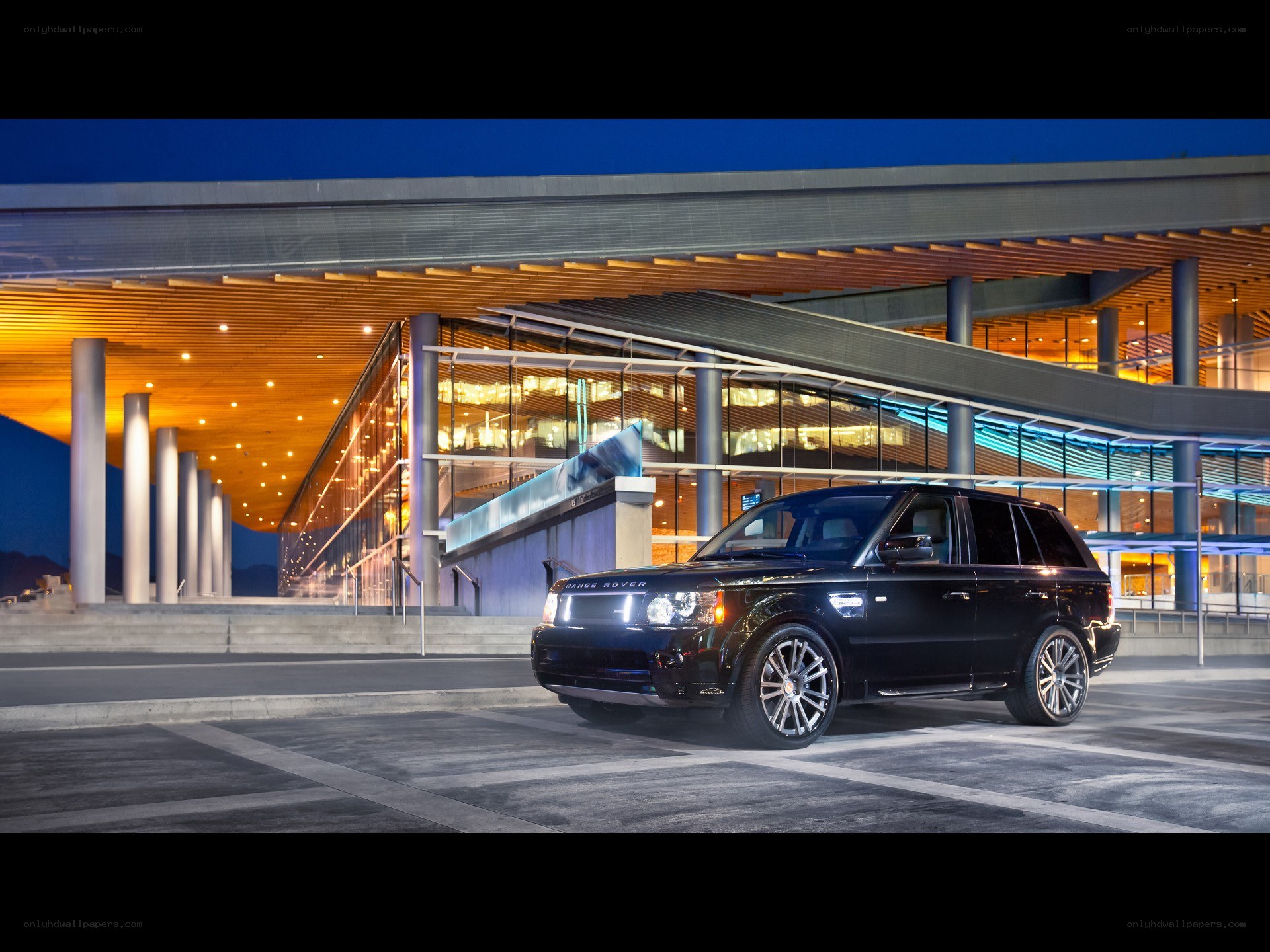 Black Range Rover at modern building