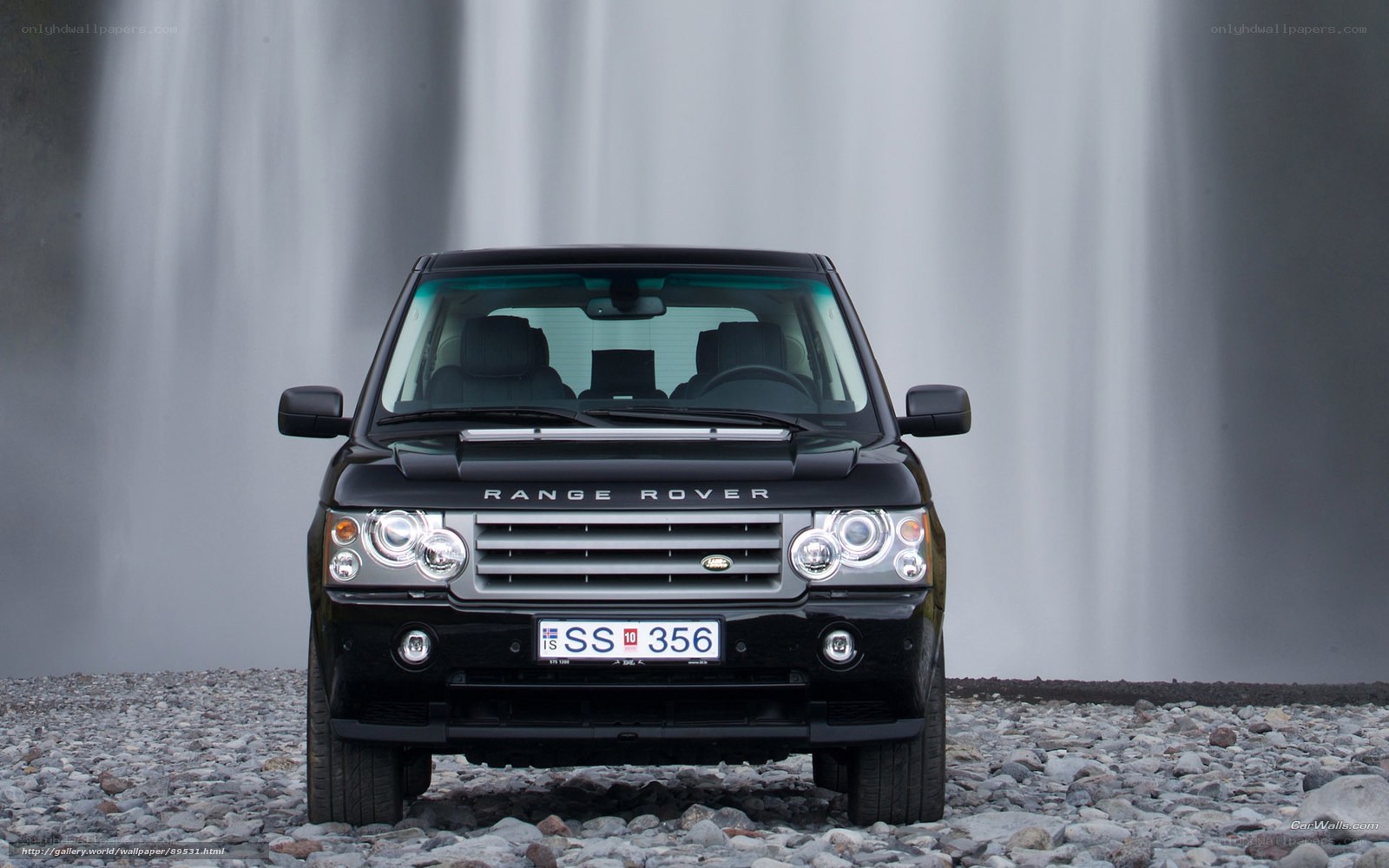 Black Range Rover in front of waterfall