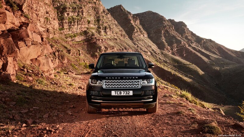 Black Range Rover in mountain landscape