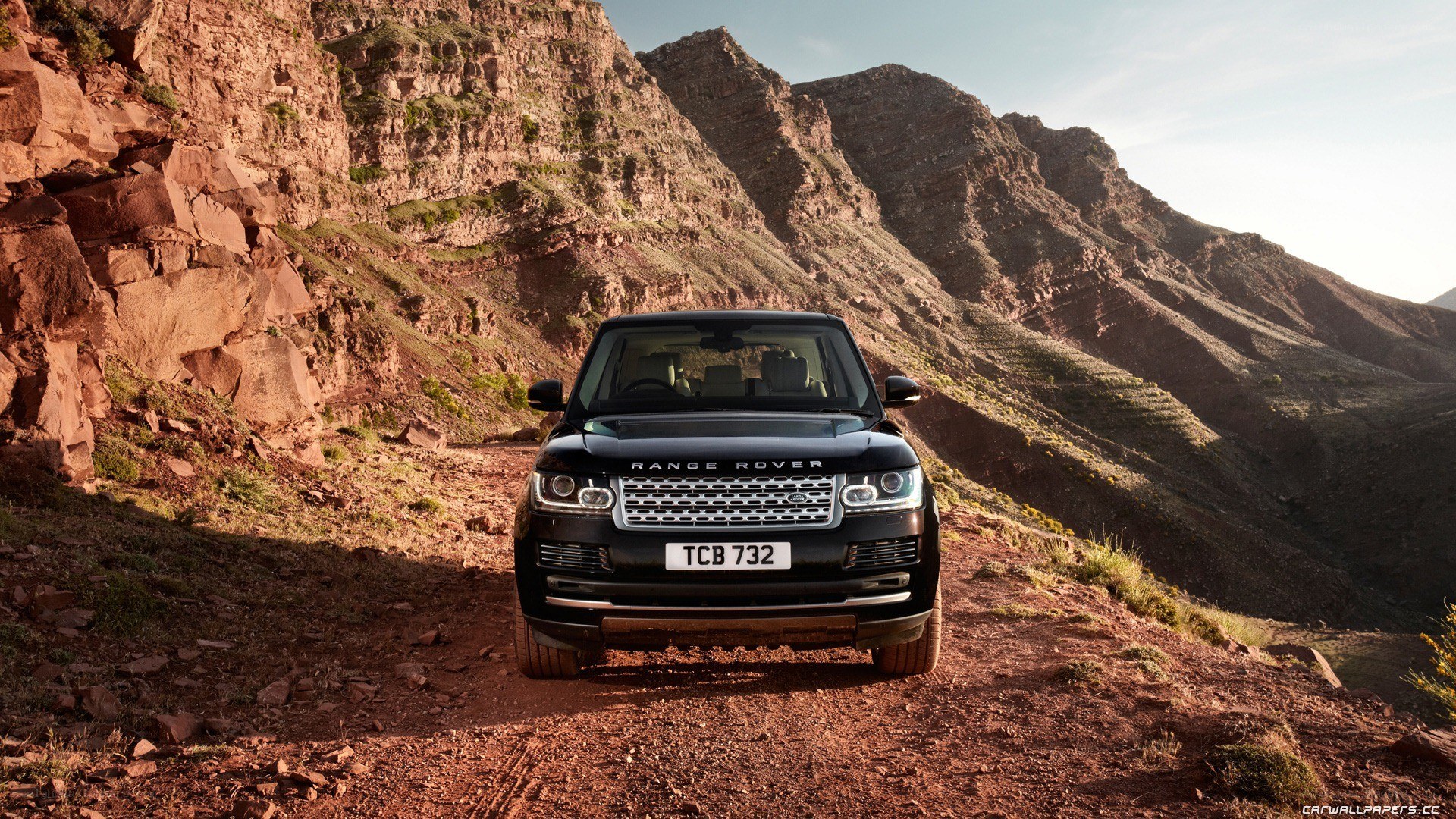Black Range Rover in mountain landscape