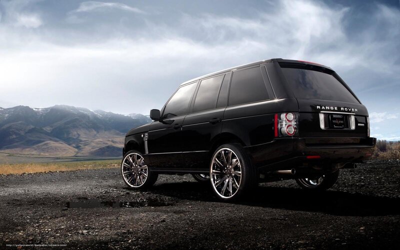 Black Range Rover in mountain landscape