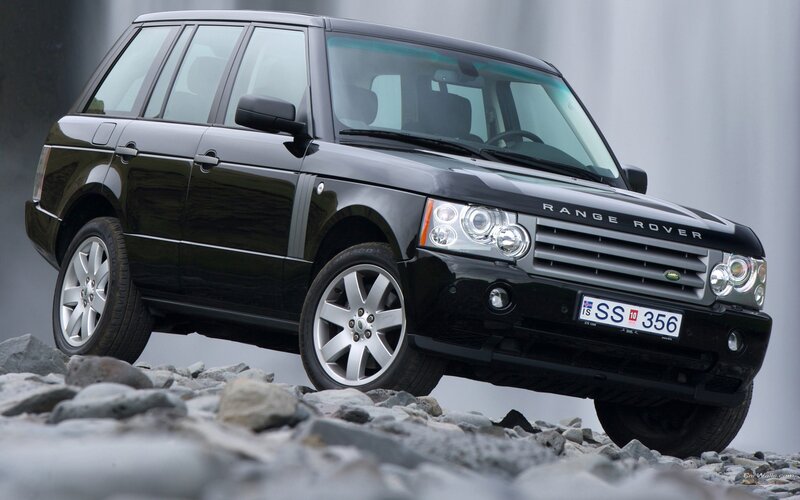 black range rover on rocks