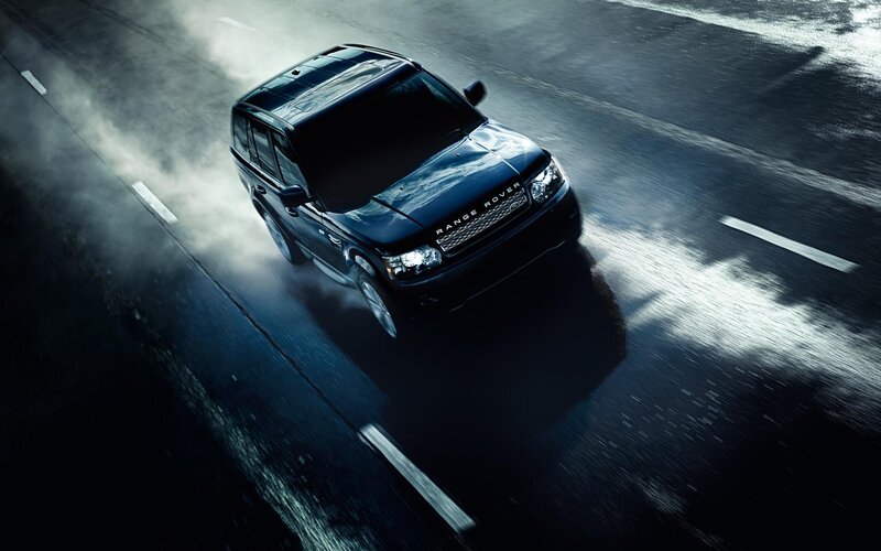 Black Range Rover on wet road