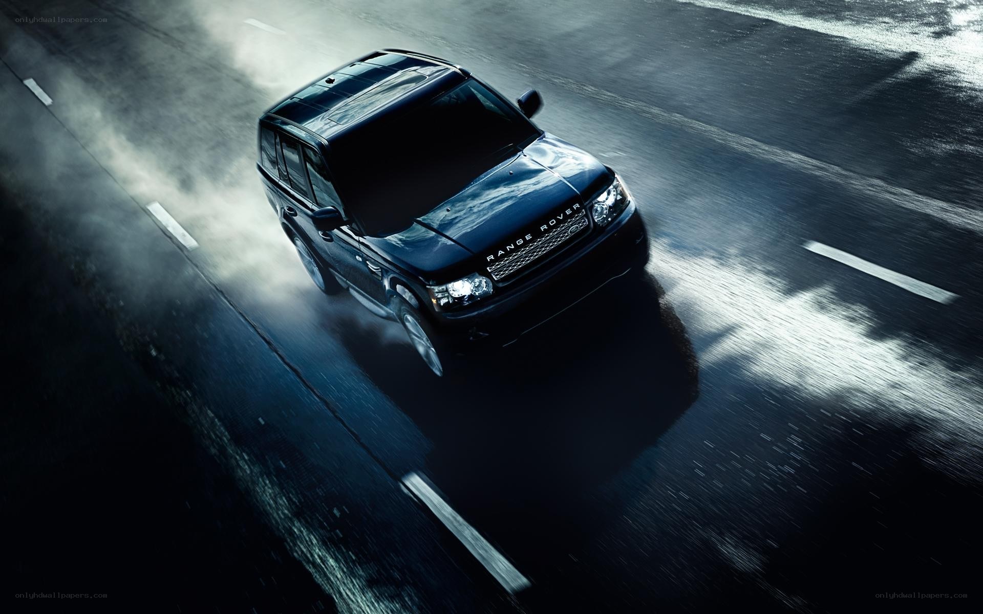 Black Range Rover on wet road