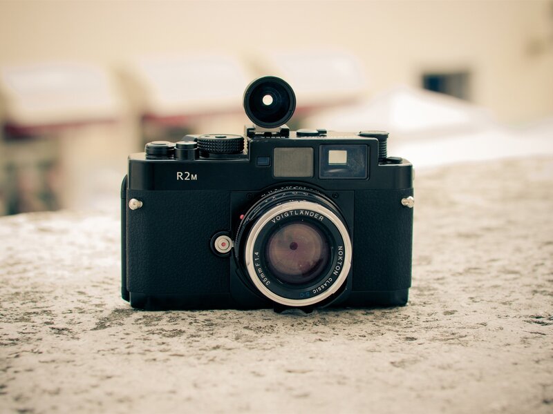 Black rangefinder camera on stone