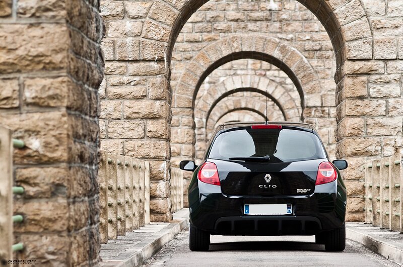Black Renault Clio under stone arches
