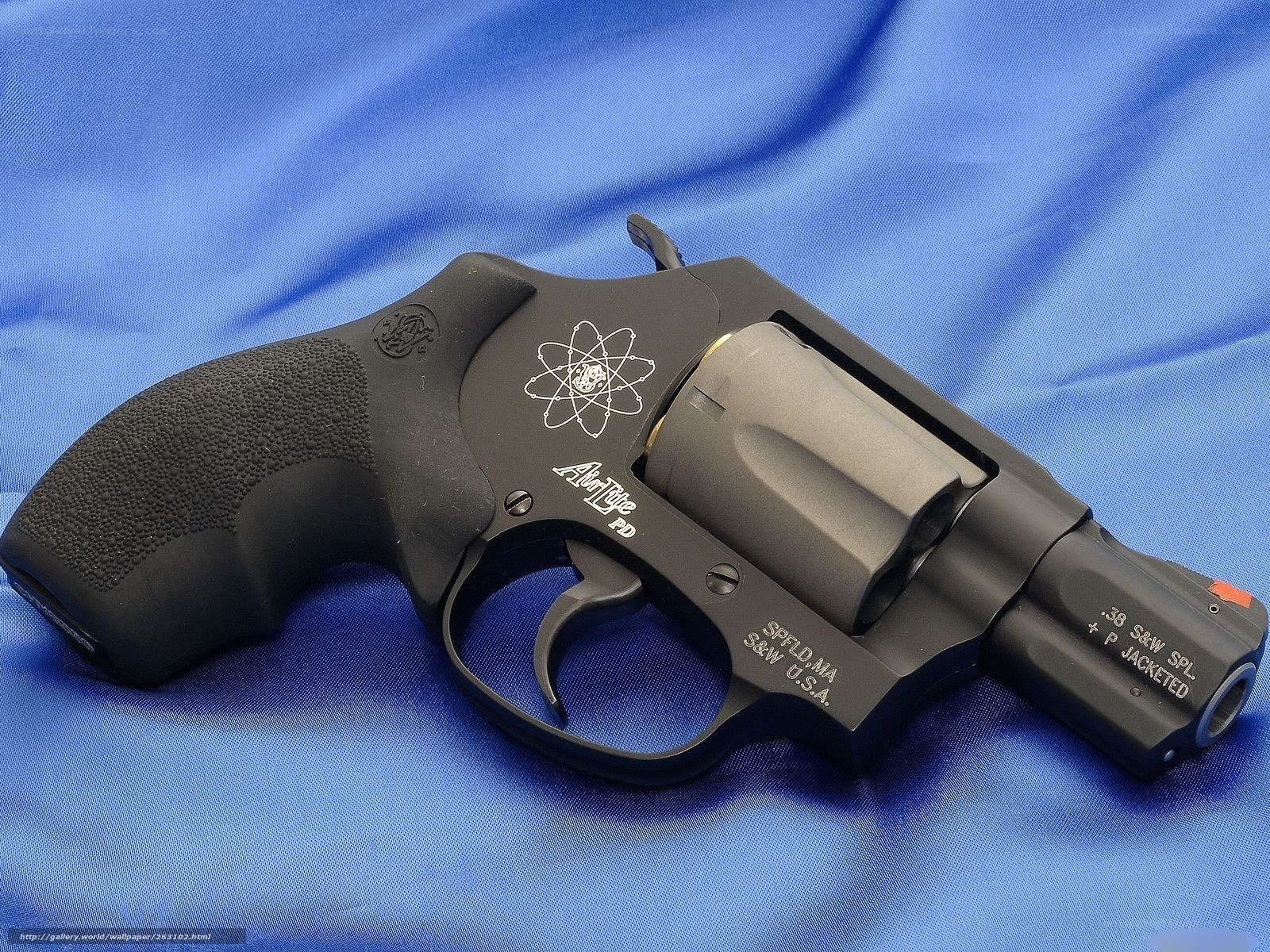 Black revolver on blue cloth