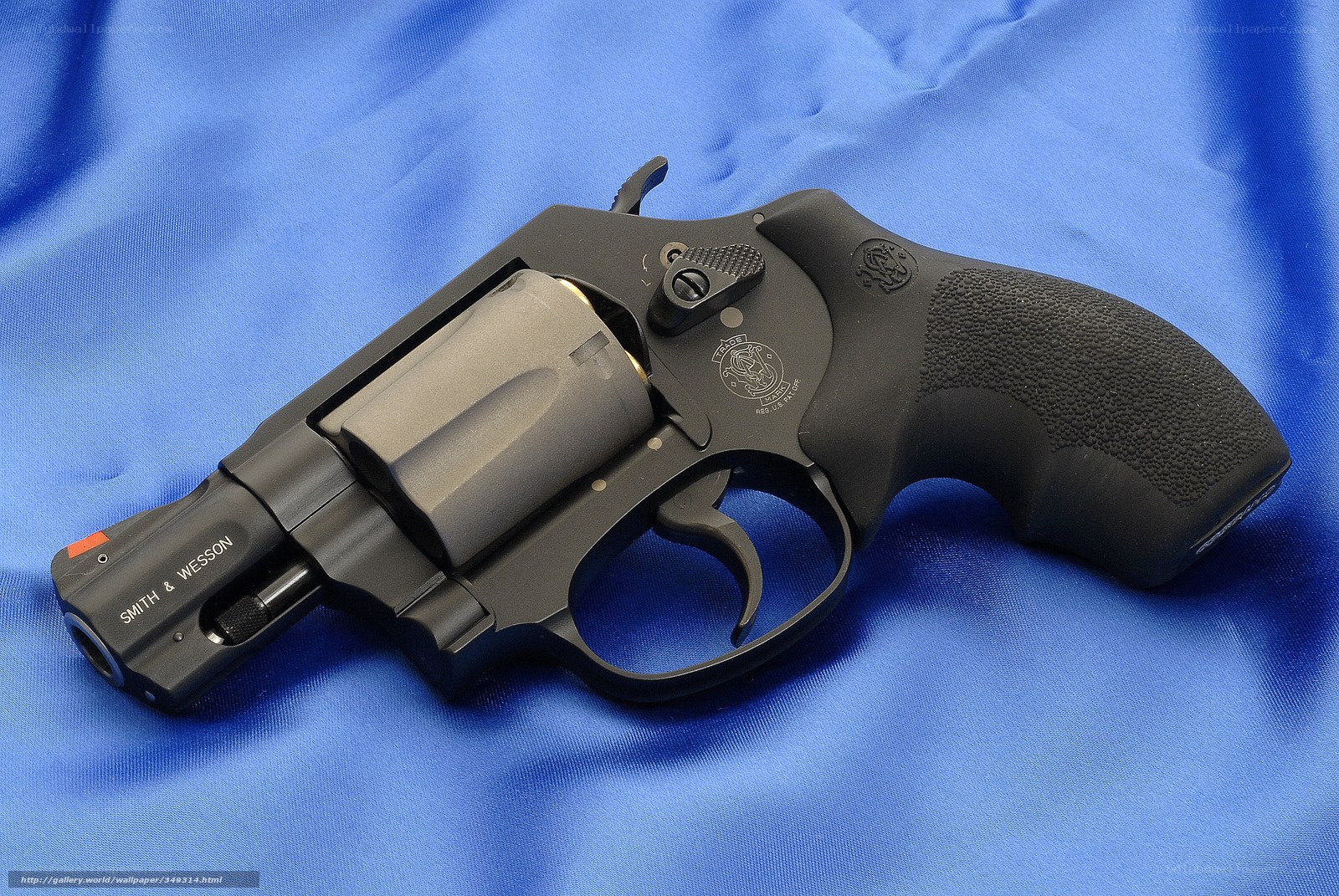 black revolver on blue cloth