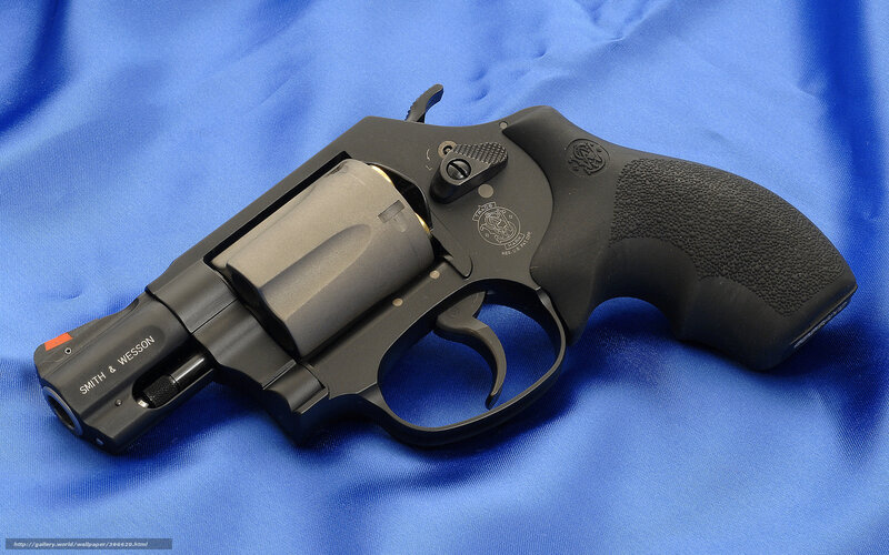 black revolver on blue cloth