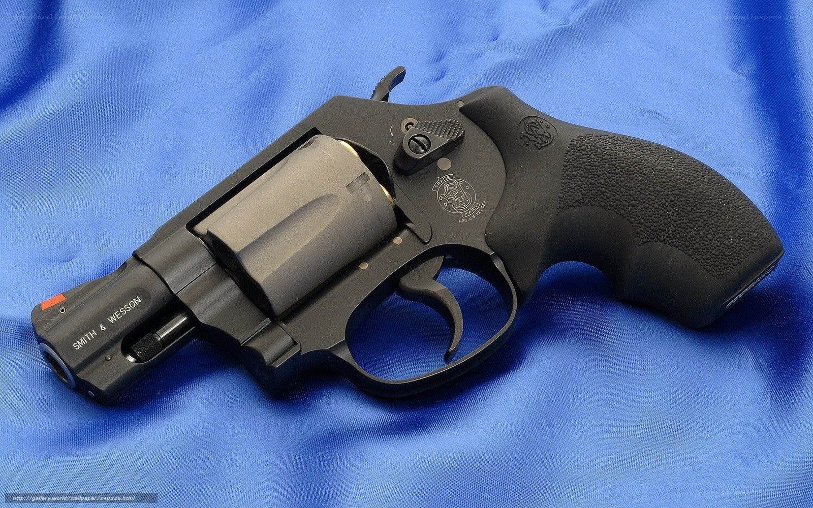 black revolver on blue cloth