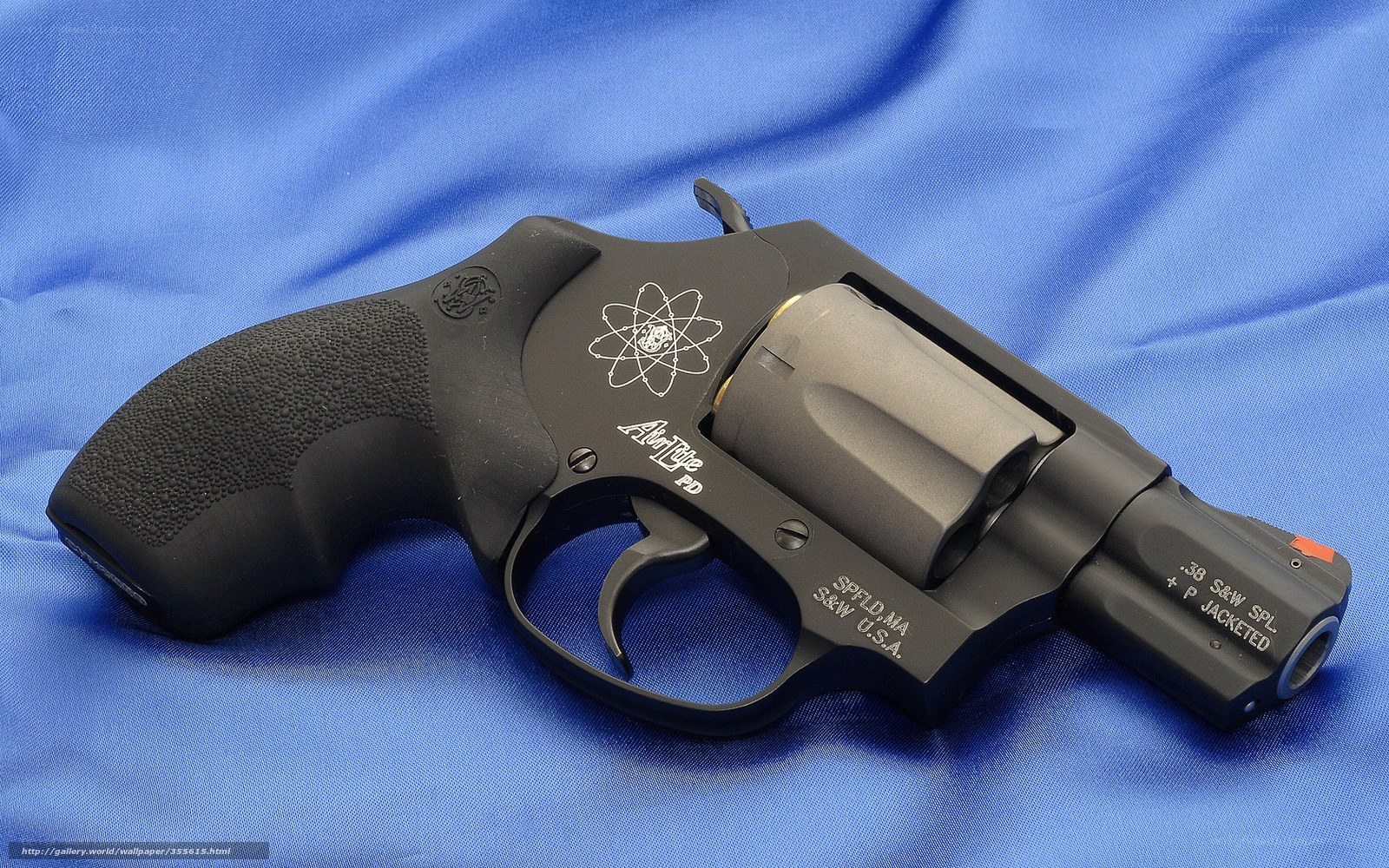 Black revolver on blue fabric