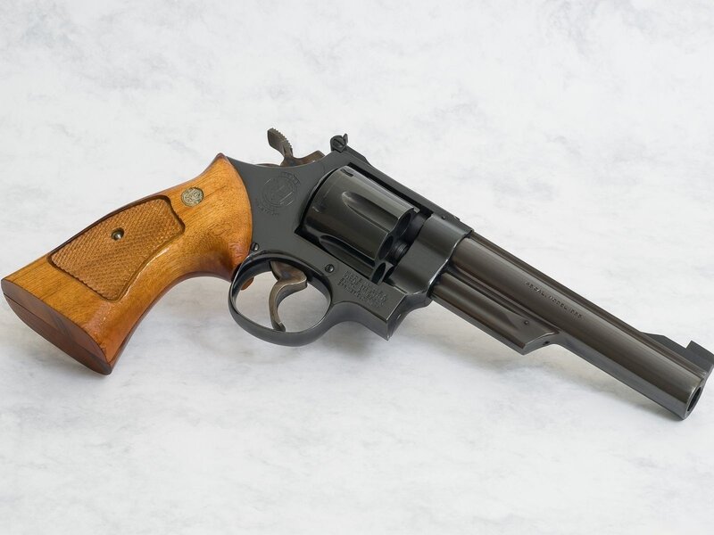 black revolver with wooden grip