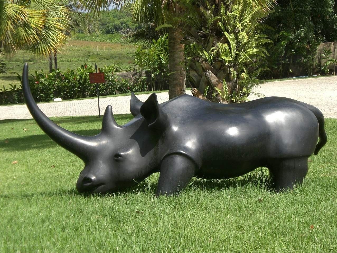 Black rhino sculpture on grass