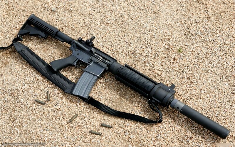 black rifle on gravel